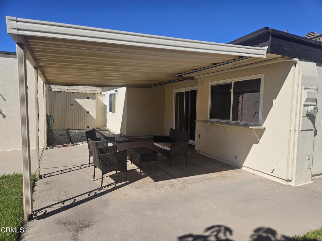 3510 Isle Way Oxnard, CA 93035 - Photo 18 of 26 a view of a patio with table and chairs with wooden floor and fence