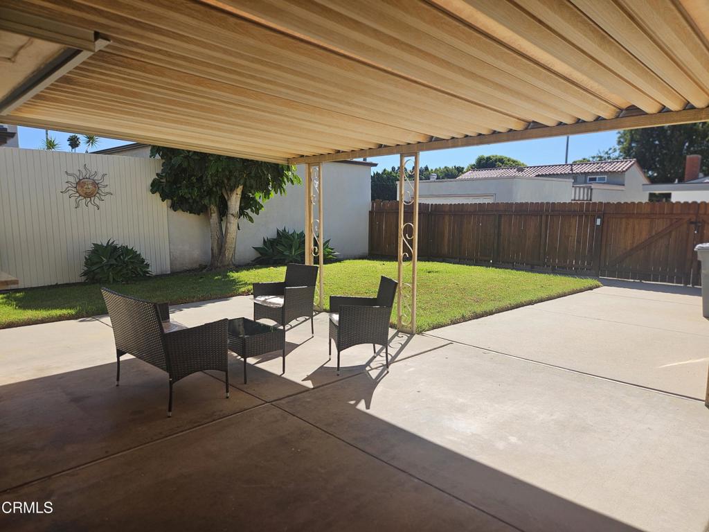 3510 Isle Way Oxnard, CA 93035 - Photo 20 of 26 a view of a patio with table and chairs under an umbrella