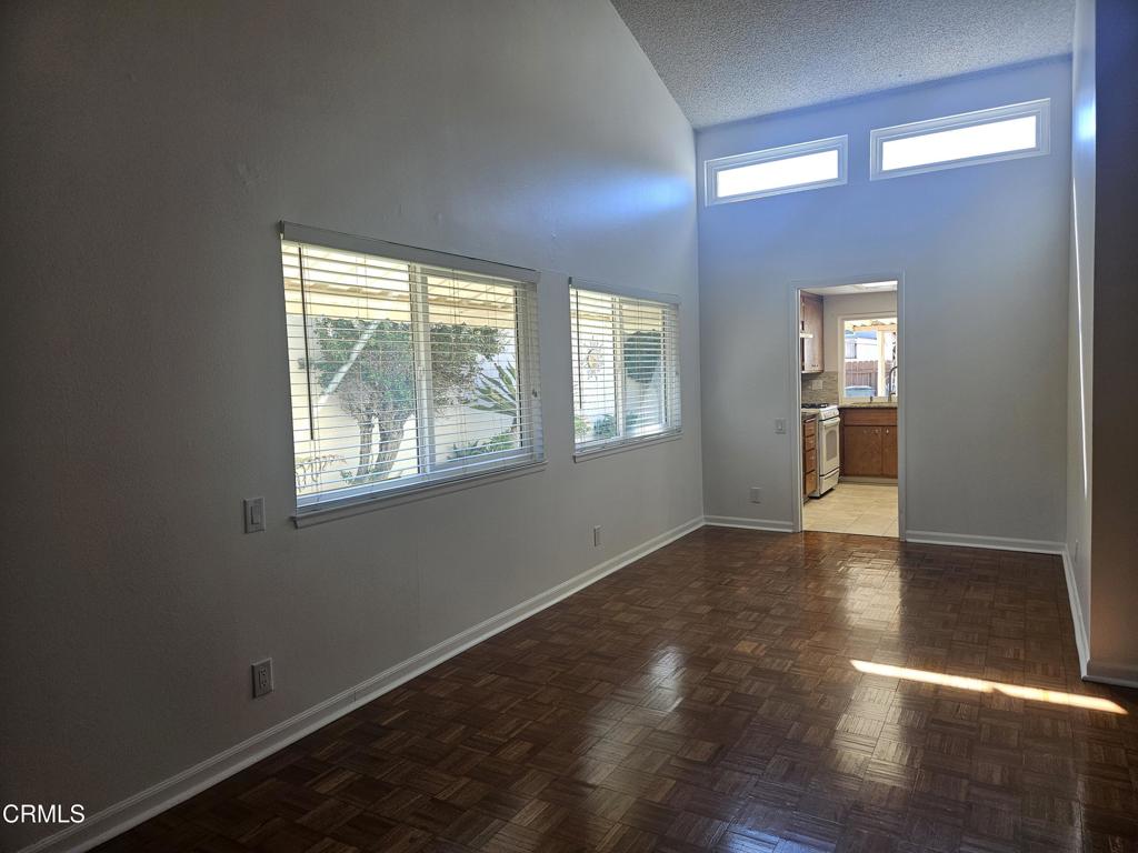 3510 Isle Way Oxnard, CA 93035 - Photo 7 of 26 an empty room with wooden floor and windows