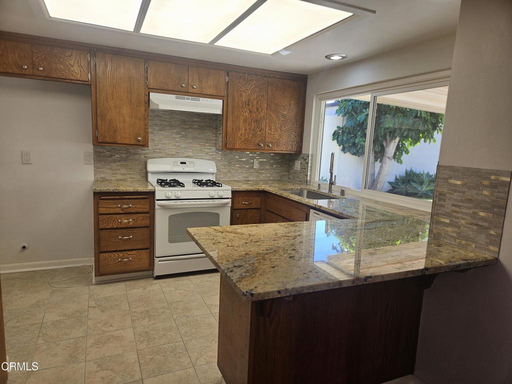 3510 Isle Way Oxnard, CA 93035 - Photo 9 of 26 a kitchen with appliances cabinets and a large window