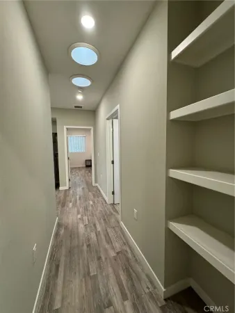 a view of hallway with wooden floor
