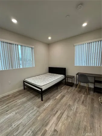 a living room with furniture pool table wooden floor and a window