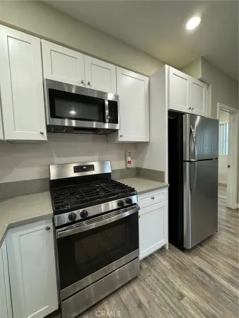 a kitchen with stainless steel appliances and white cabinets