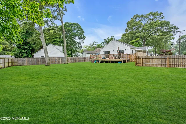 a view of a house with a yard and sitting area