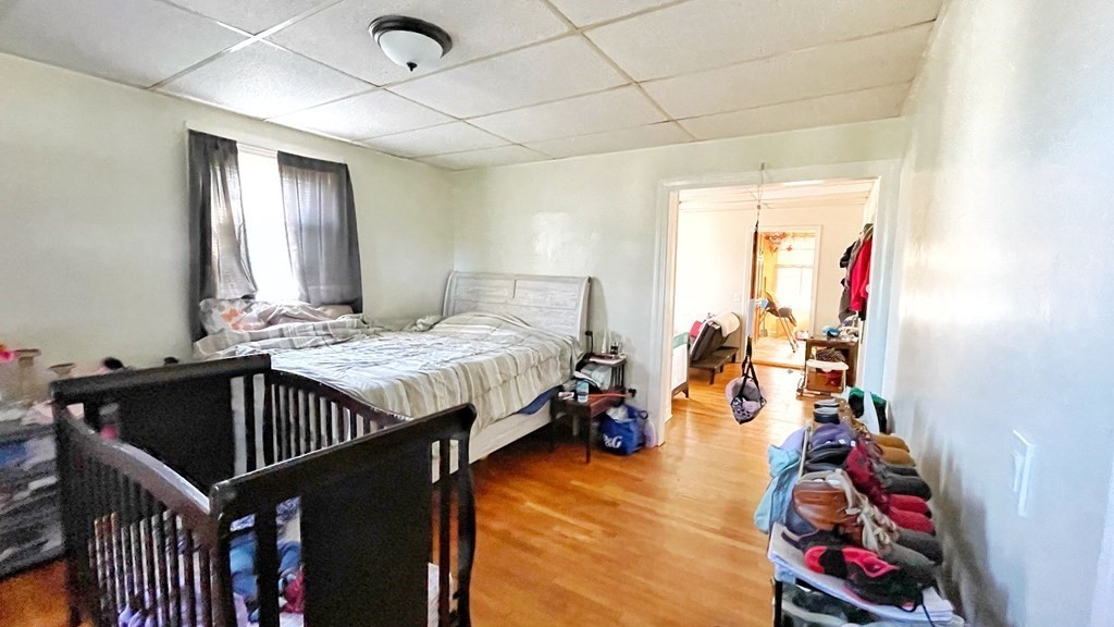550 Eastern Avenue Lynn, MA 01902 - Photo 11 of 32 a bedroom with a bed and wooden floor