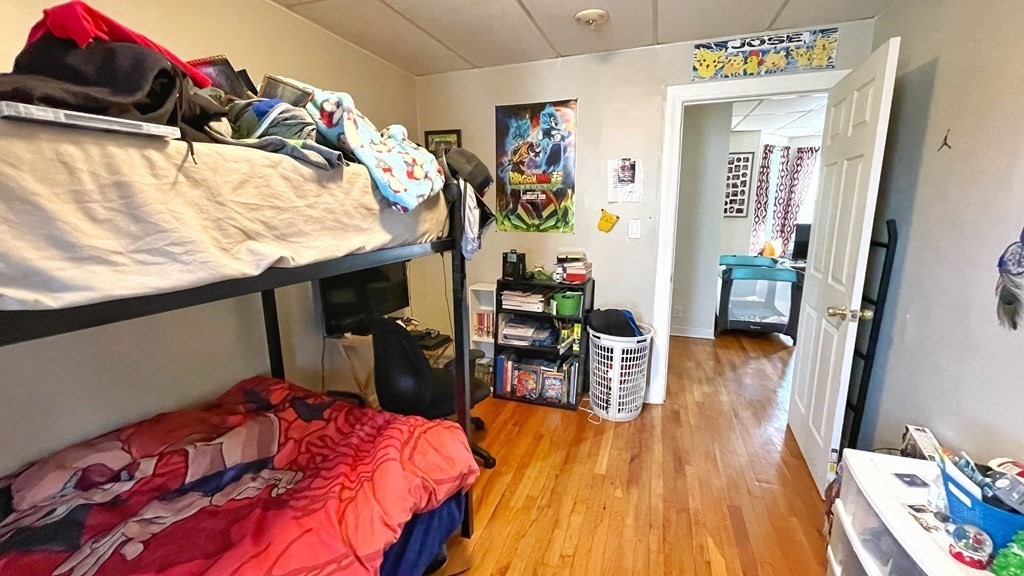 550 Eastern Avenue Lynn, MA 01902 - Photo 13 of 32 a bedroom with a bed and wooden floor