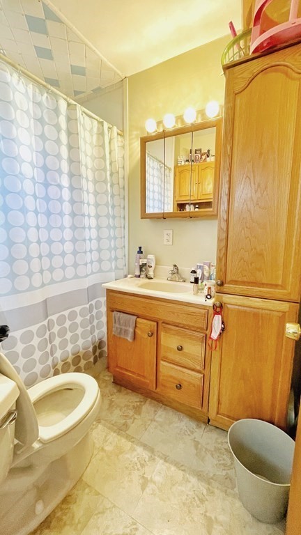 550 Eastern Avenue Lynn, MA 01902 - Photo 19 of 32 a bathroom with a sink a toilet and tub