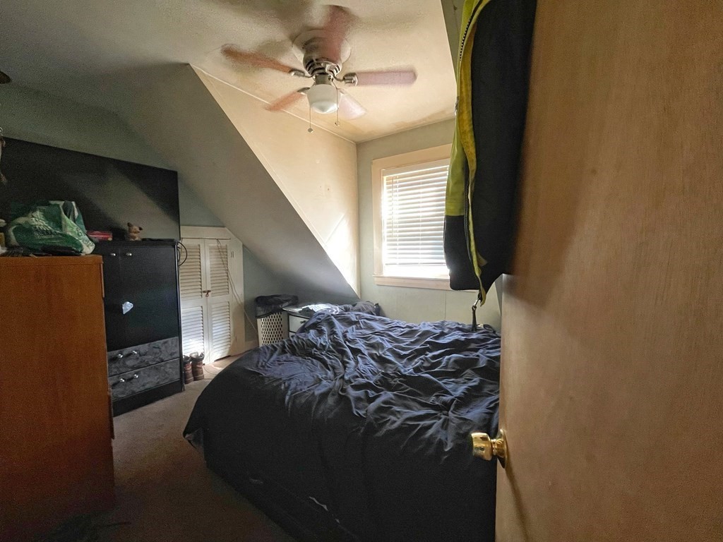 550 Eastern Avenue Lynn, MA 01902 - Photo 24 of 32 a bed sitting in a bedroom next to a window