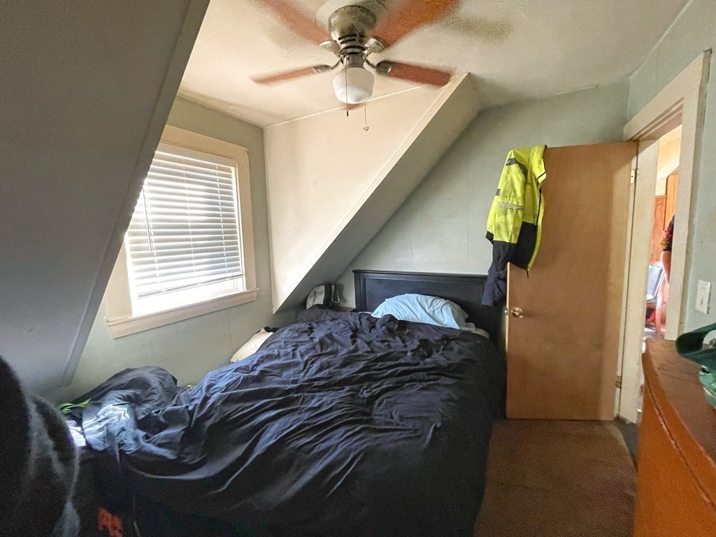 550 Eastern Avenue Lynn, MA 01902 - Photo 25 of 32 a bedroom with a bed and a chandelier