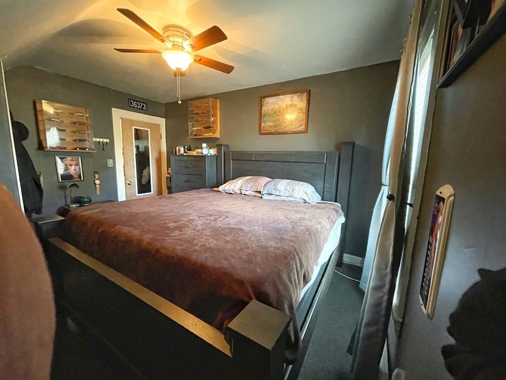 550 Eastern Avenue Lynn, MA 01902 - Photo 28 of 32 a bedroom with a bed and a chandelier