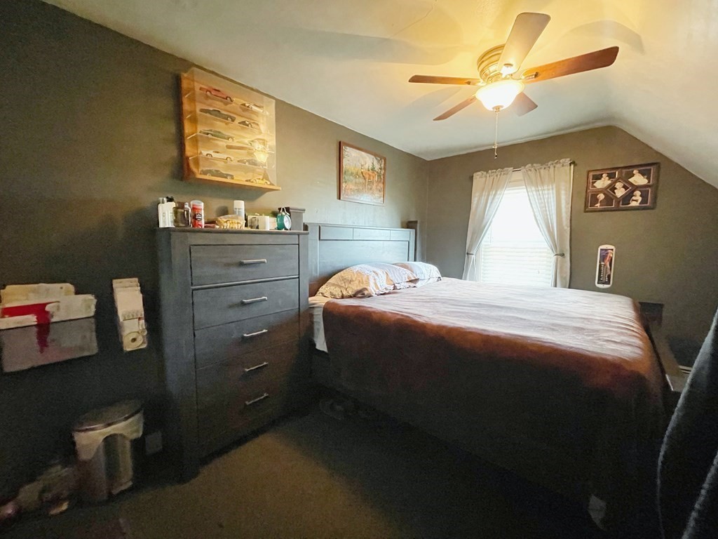 550 Eastern Avenue Lynn, MA 01902 - Photo 29 of 32 a bedroom with a bed and a chandelier