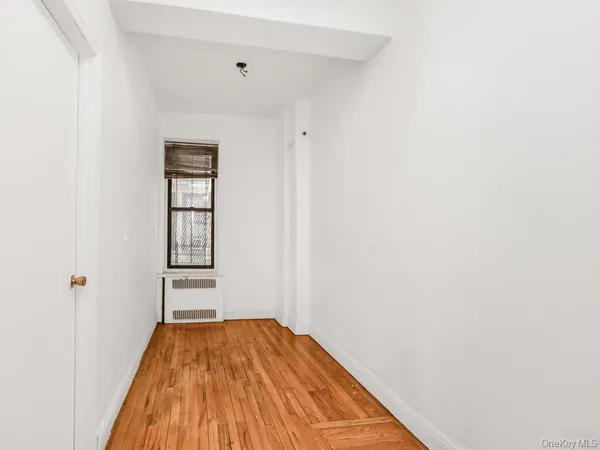 a view of a room with wooden floor and closet
