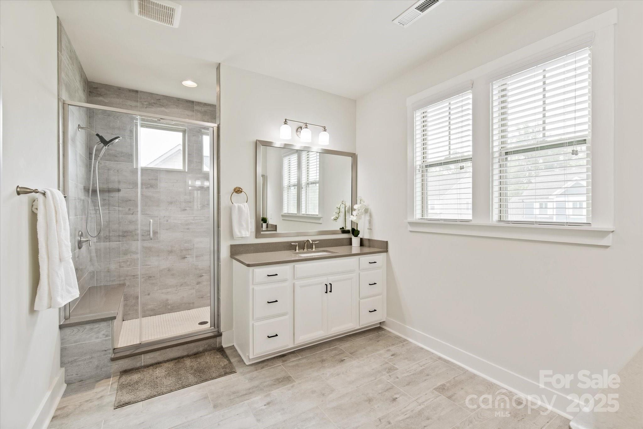 1244 Weir Court Fort Mill, SC 29708 - Photo 24 of 48 a bathroom with a granite countertop sink a mirror and a shower