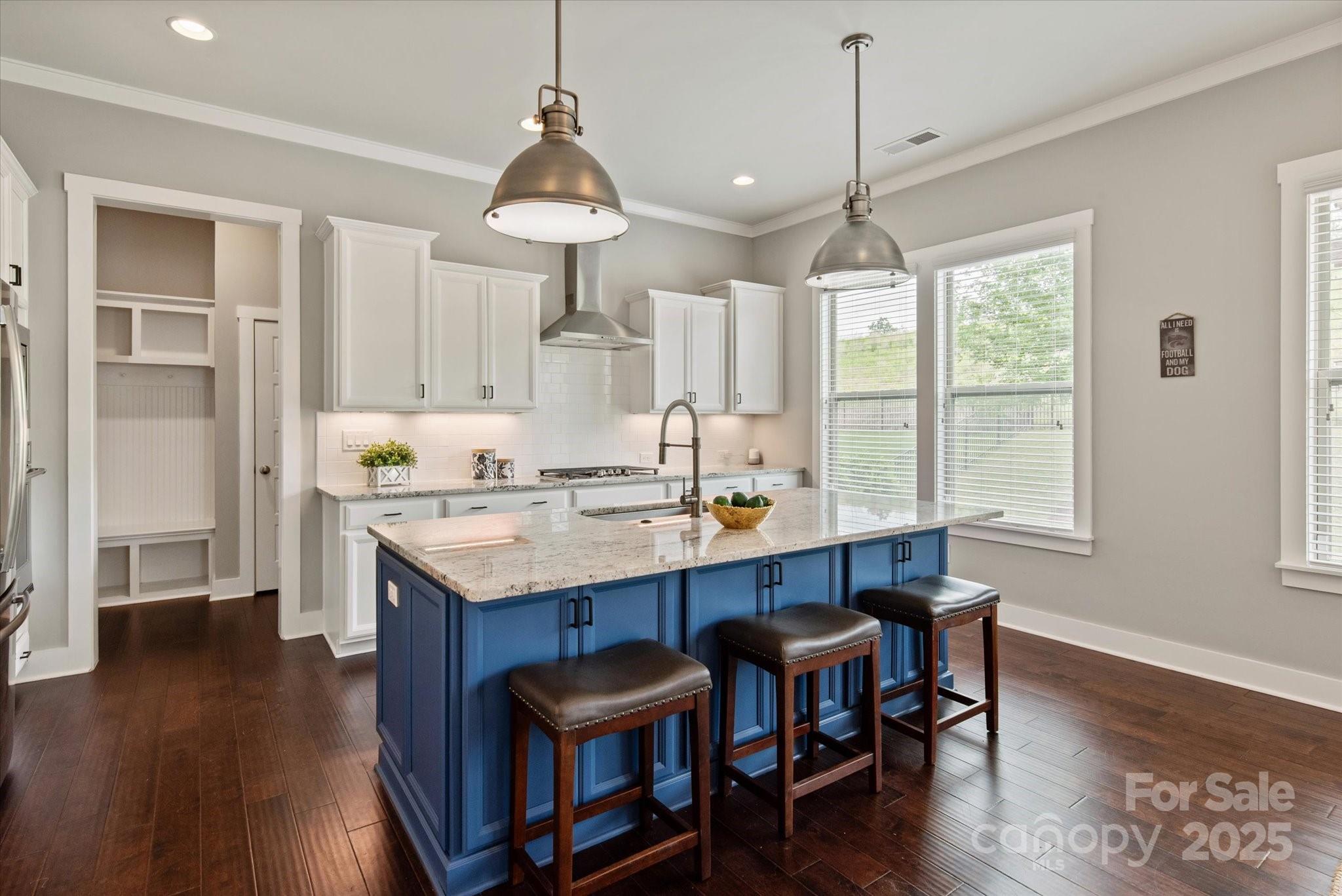 1244 Weir Court Fort Mill, SC 29708 - Photo 8 of 48 a room with stainless steel appliances kitchen island granite countertop a table chairs and a wooden floor