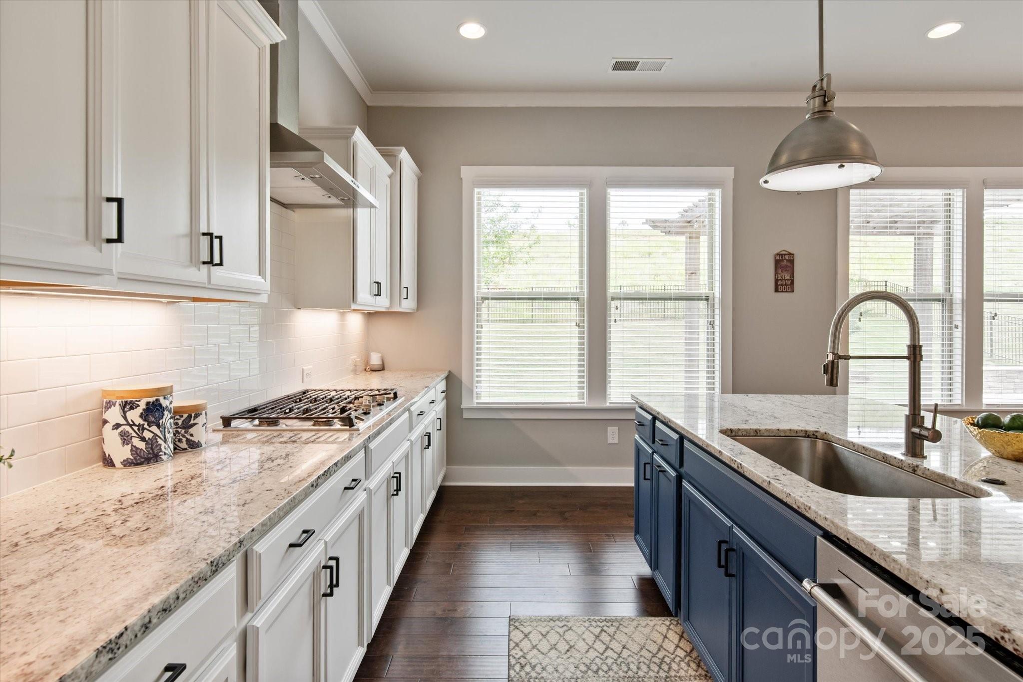 1244 Weir Court Fort Mill, SC 29708 - Photo 9 of 48 a kitchen with granite countertop a sink stove and cabinets