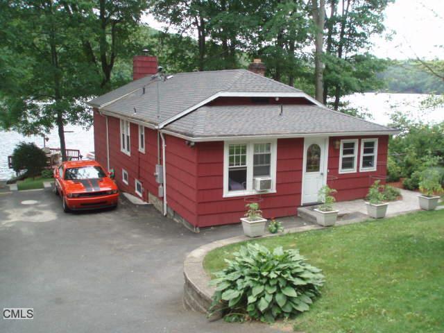 30 Underhill Road Newtown, CT 06482 - Photo 1 of 1 a white house covered with tall trees