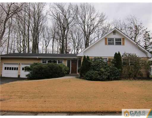 11 Timber Road Edison, NJ 08820 - Photo 3 of 17 a front view of house with yard and trees in the background
