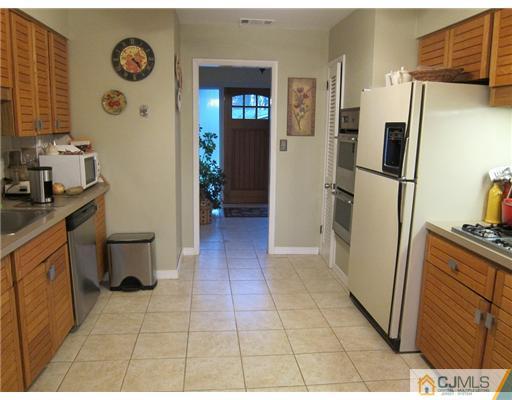 11 Timber Road Edison, NJ 08820 - Photo 4 of 17 a kitchen with a refrigerator and a stove
