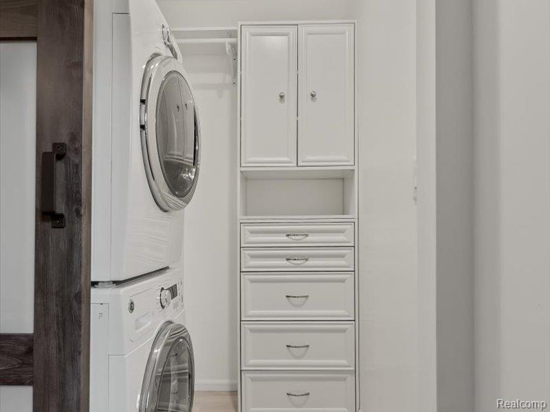 29213 Rachid Lane New Baltimore, MI 48047 - Photo 14 of 26 Laundry area with cabinet space and stacked washer / dryer