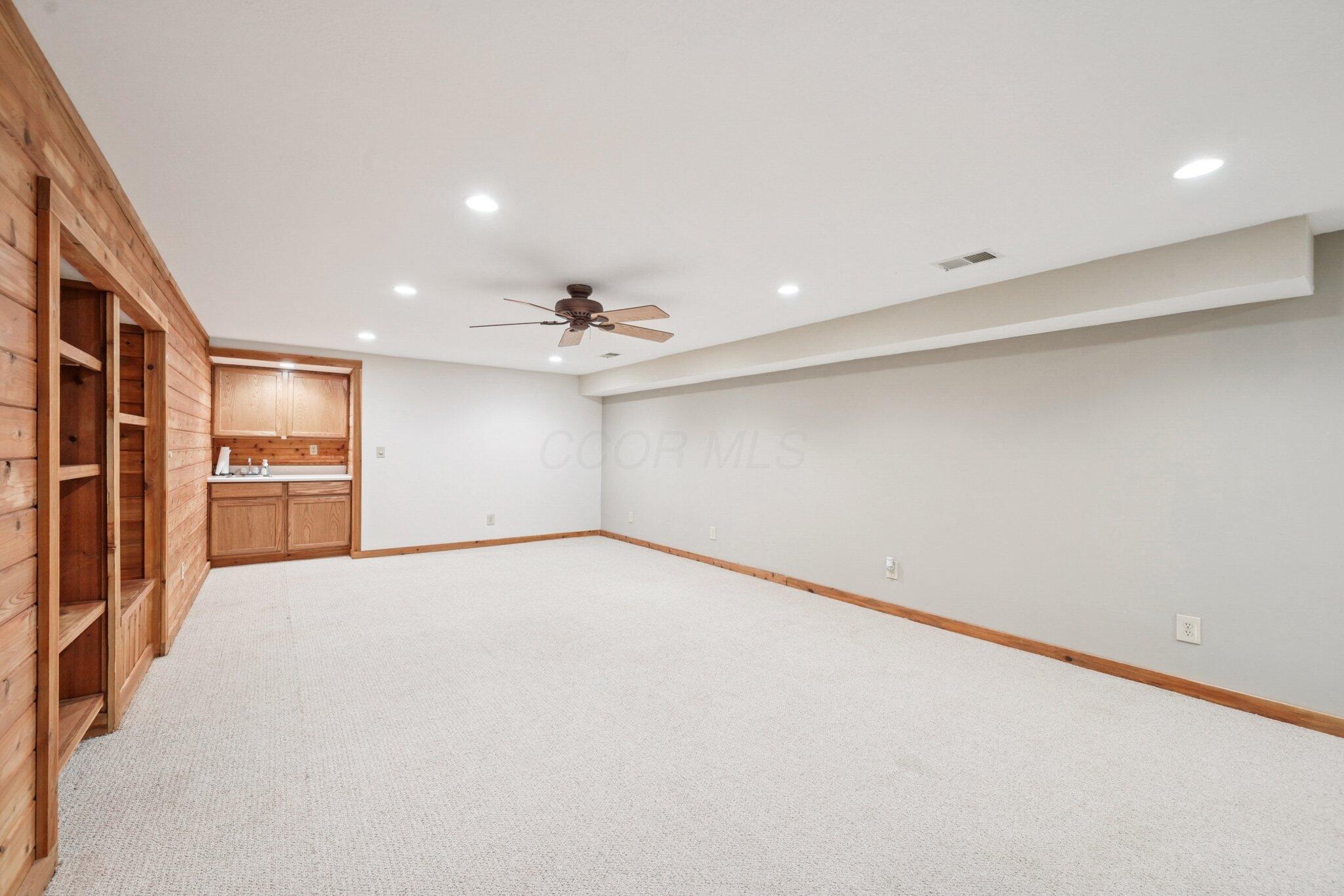 7700 Plumb Road Galena, OH 43021 - Photo 77 of 94 Another angle of the finished lower level showcasing a convenient wet bar and open layout.