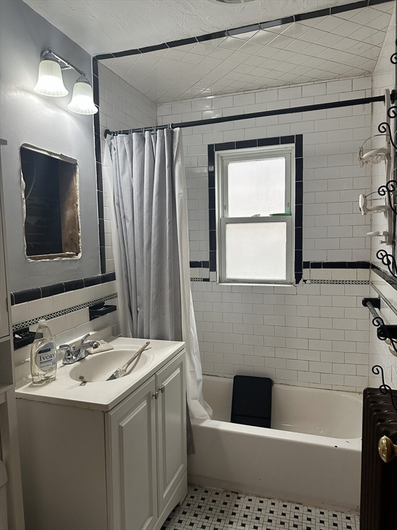 33 Amsden Street, Unit 1 Arlington, MA 02474 - Photo 11 of 18 a bathroom with a sink a toilet and shower