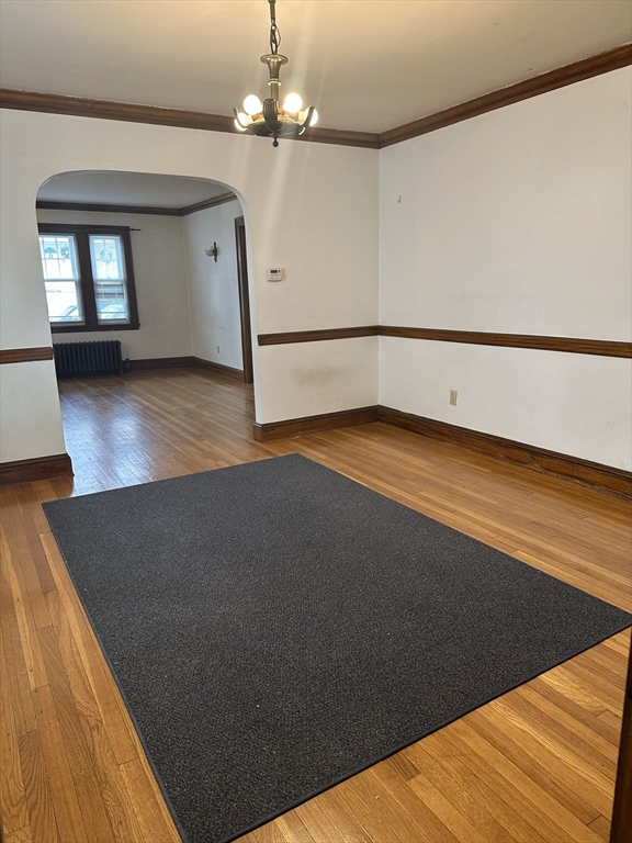 33 Amsden Street, Unit 1 Arlington, MA 02474 - Photo 2 of 18 wooden floor in an empty room with a window