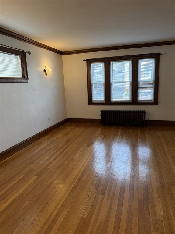 33 Amsden Street, Unit 1 Arlington, MA 02474 - Photo 3 of 18 a view of a room with wooden floor and window