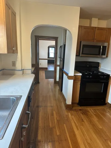 a kitchen with sink and refrigerator