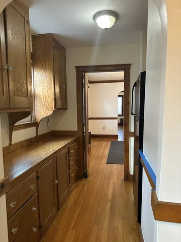 a kitchen with granite countertop a stove and a microwave with wooden floor