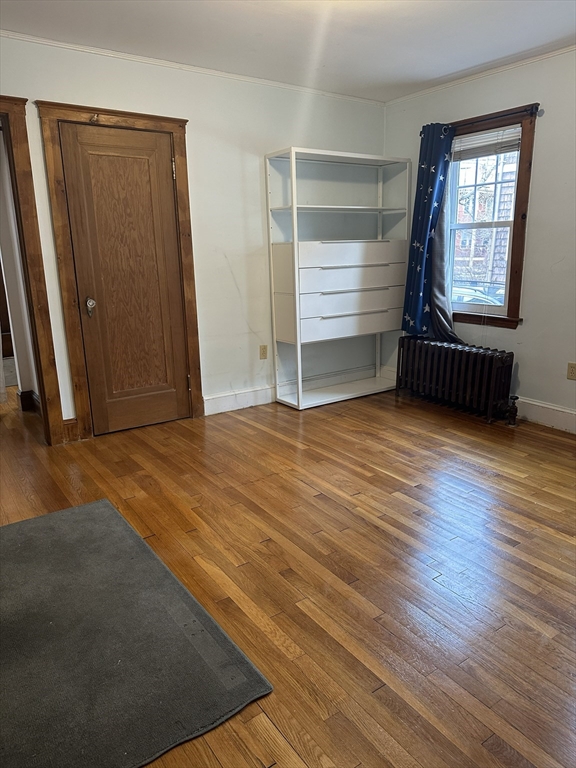 33 Amsden Street, Unit 1 Arlington, MA 02474 - Photo 10 of 18 an empty room with wooden floor and windows