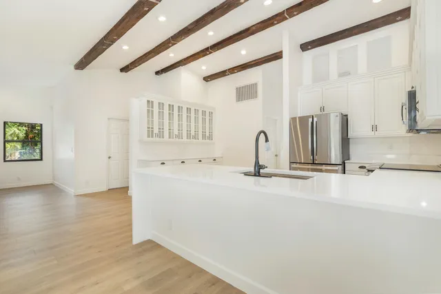 a view of an empty room with a fireplace and a window