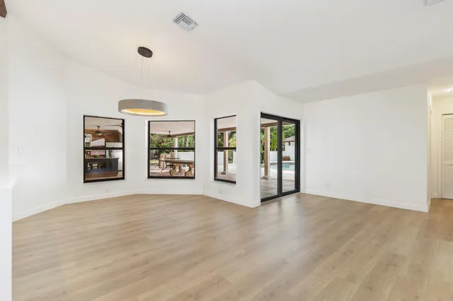 a view of an empty room with a fireplace and a window