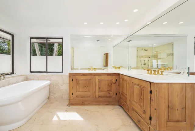 a bathroom with a granite countertop sink toilet and mirror