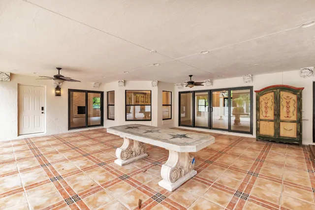 a front view of a house with a yard and potted plants