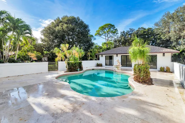 a view of house with swimming pool outdoor seating
