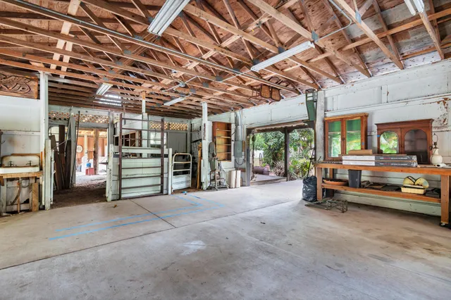 an aerial view of residential houses with outdoor space and trees