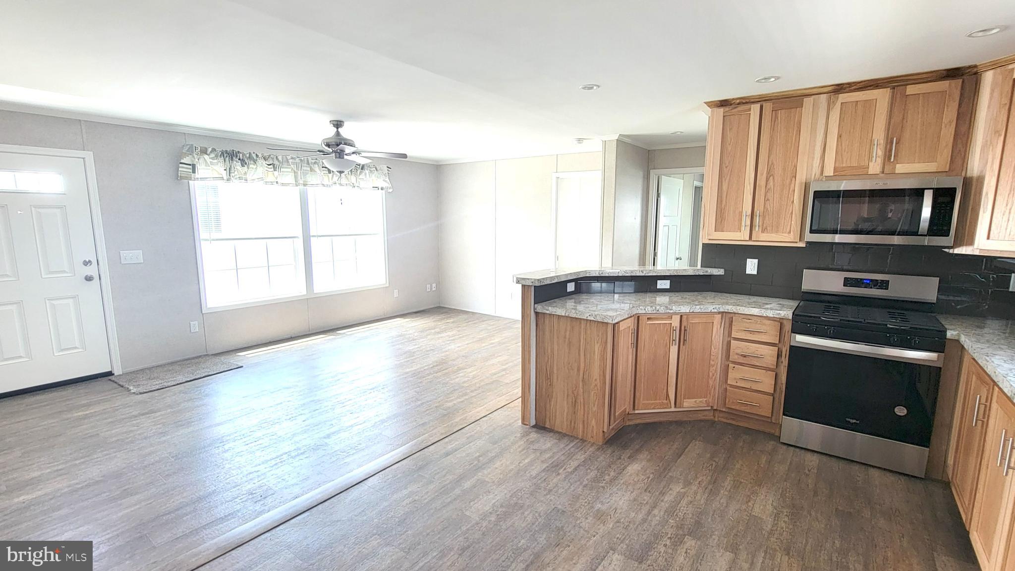 4 Joseph Avenue Birdsboro, PA 19508 - Photo 5 of 19 a kitchen with granite countertop a stove a sink and a microwave