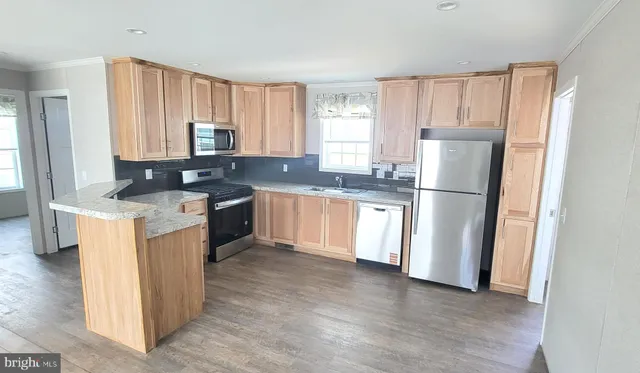 a kitchen with a refrigerator a sink and cabinets
