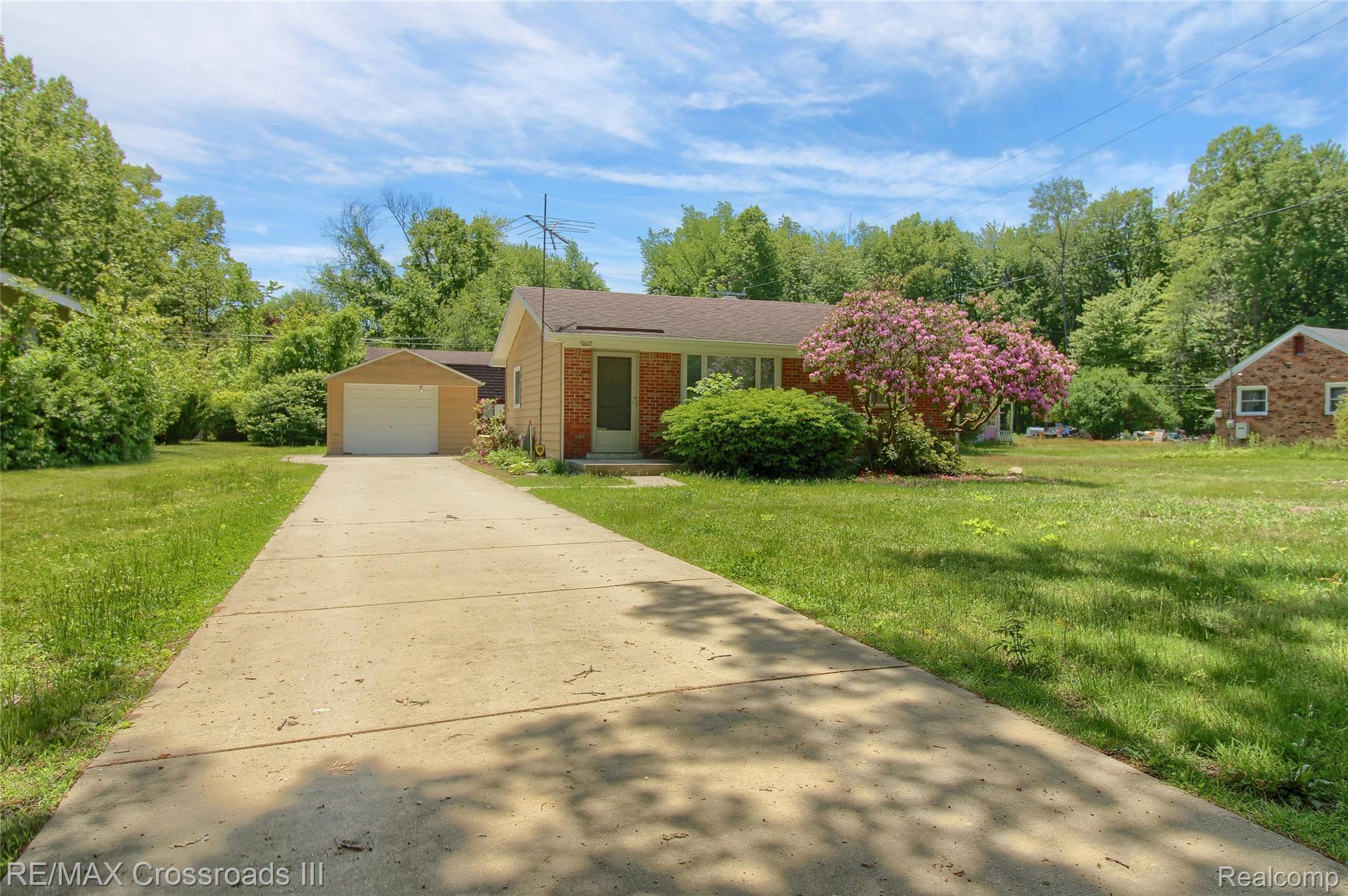 41509 Riggs Road Belleville, MI 48111 - Photo 2 of 26 Ranch-style residence featuring brick siding and a concrete driveway