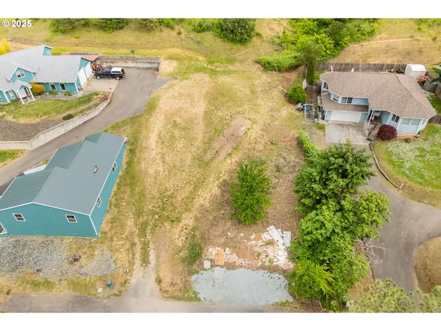 an aerial view of a house with a yard basket ball court and outdoor seating