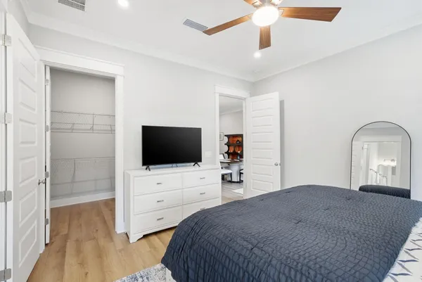 a bedroom with a bed and a flat screen tv