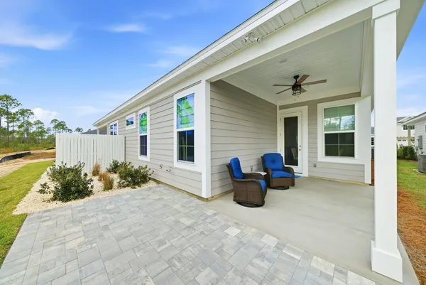 a view of a patio with chairs and potted plants