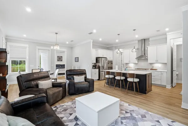 a living room with stainless steel appliances kitchen island granite countertop furniture and a kitchen view