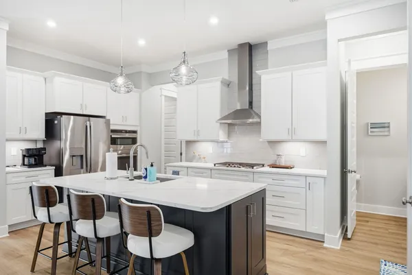 a kitchen with stainless steel appliances a sink stove and refrigerator
