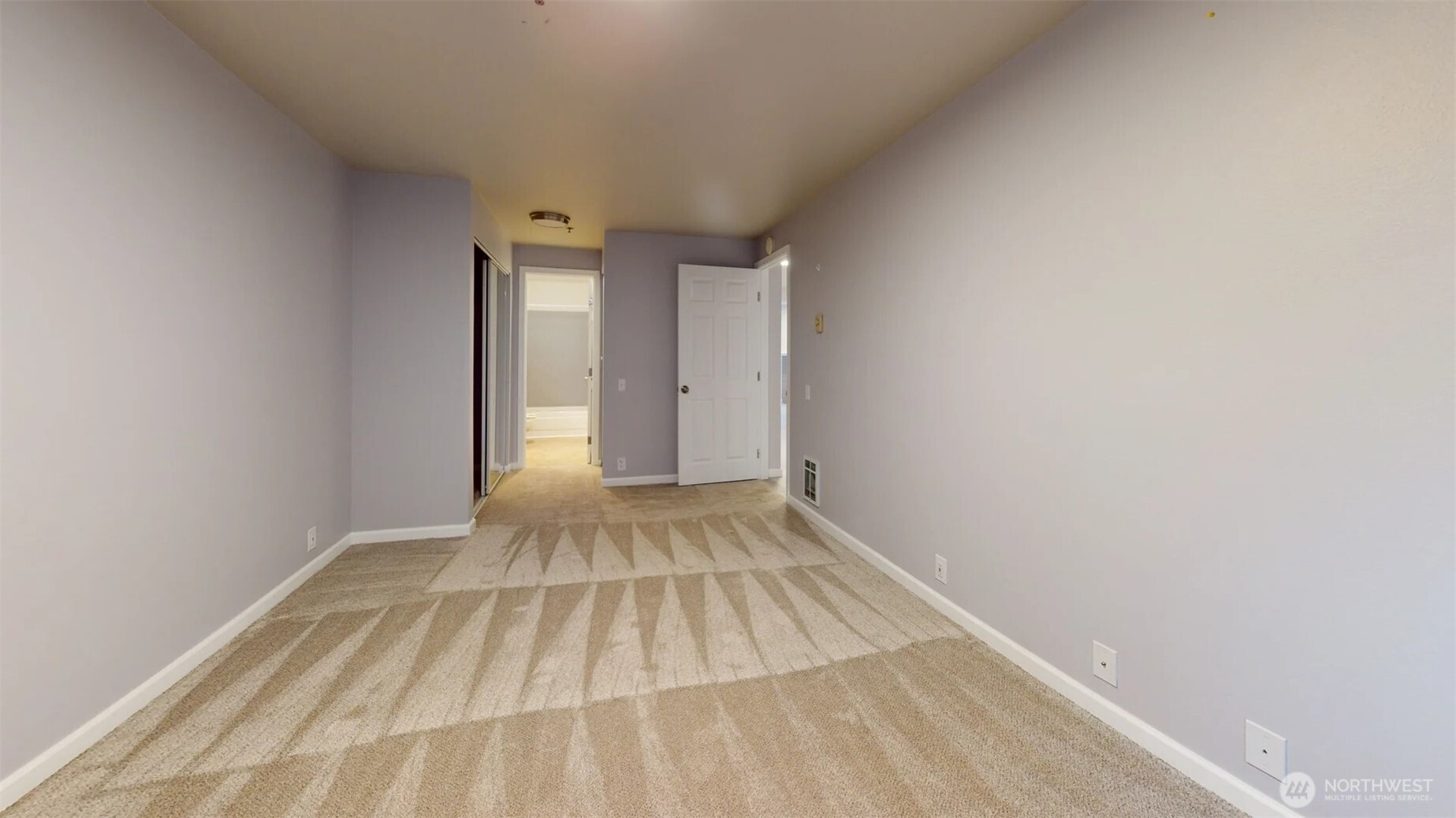 29645 18th Avenue South, Unit A303 Federal Way, WA 98003 - Photo 12 of 19 a view of a room with wooden floor and white doors