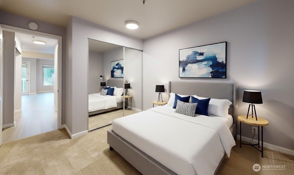 29645 18th Avenue South, Unit A303 Federal Way, WA 98003 - Photo 15 of 19 a bedroom with a bed and a mirror