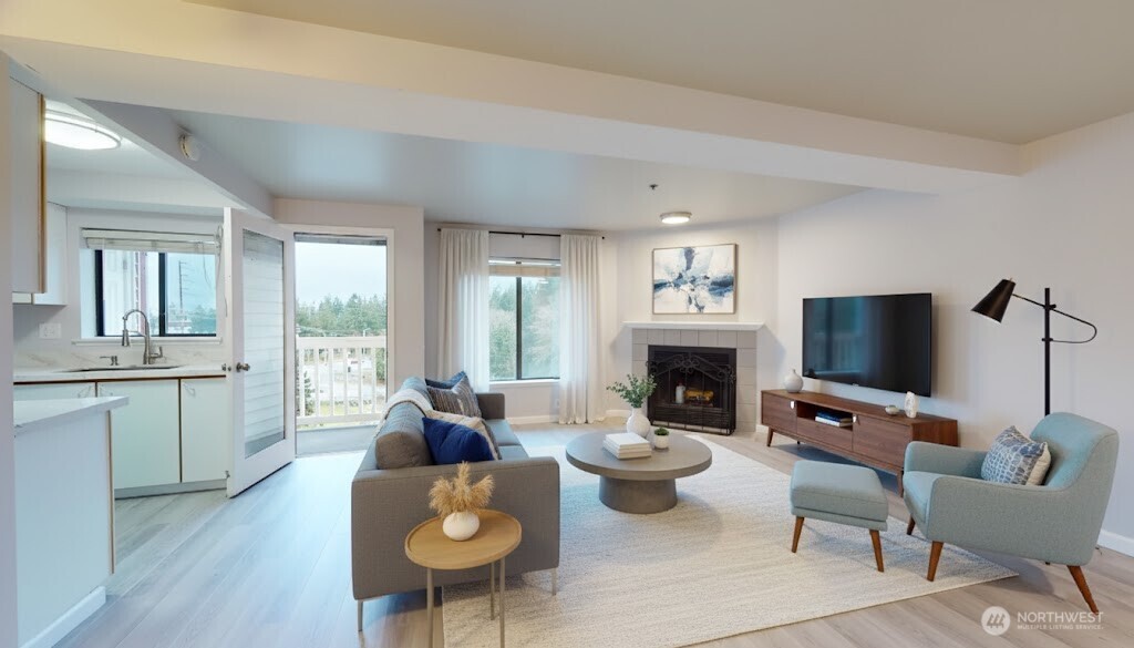 29645 18th Avenue South, Unit A303 Federal Way, WA 98003 - Photo 2 of 19 a living room with furniture a fireplace and a flat screen tv