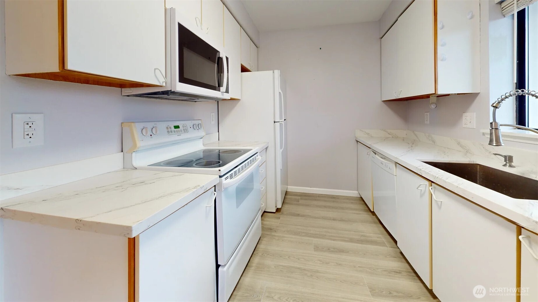 29645 18th Avenue South, Unit A303 Federal Way, WA 98003 - Photo 7 of 19 a kitchen with a sink and a microwave
