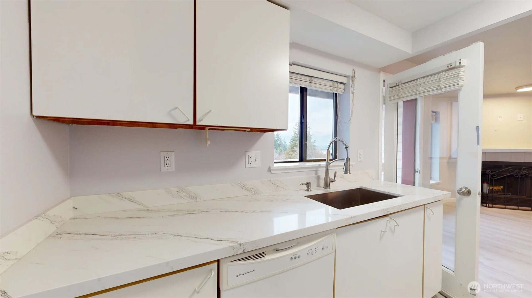 29645 18th Avenue South, Unit A303 Federal Way, WA 98003 - Photo 8 of 19 a kitchen with a sink and cabinets