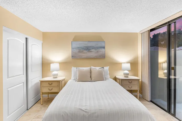 a bedroom with a bed and a lamp